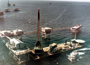 When we think of a platform, we usually think of a single structure, but many platforms were in reality complexes of structures joined together into small offshore cities. The 1968 photo below shows the last module for such a structure about to be placed on the deck of the platform. Such complexes were not unique to the Gulf of Mexico; they also appeared in the North Sea and other places around the world.