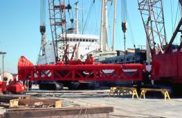 Another view of loading out a hammer package, this time being lifted off of the quay to be set on the deck of the ship.