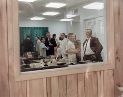 Looking through the receptionist's window into the secretarial pool office. Behind the glass, facing right and holding a drink is a very young Pem Warrington, later Executive Vice President, who would "office remotely" from the Houston facility from 1978 to 1992. He is taking with Capt. Jim North, whose nephew Bob would work as a sales manager for Vulcan in the 1970's.